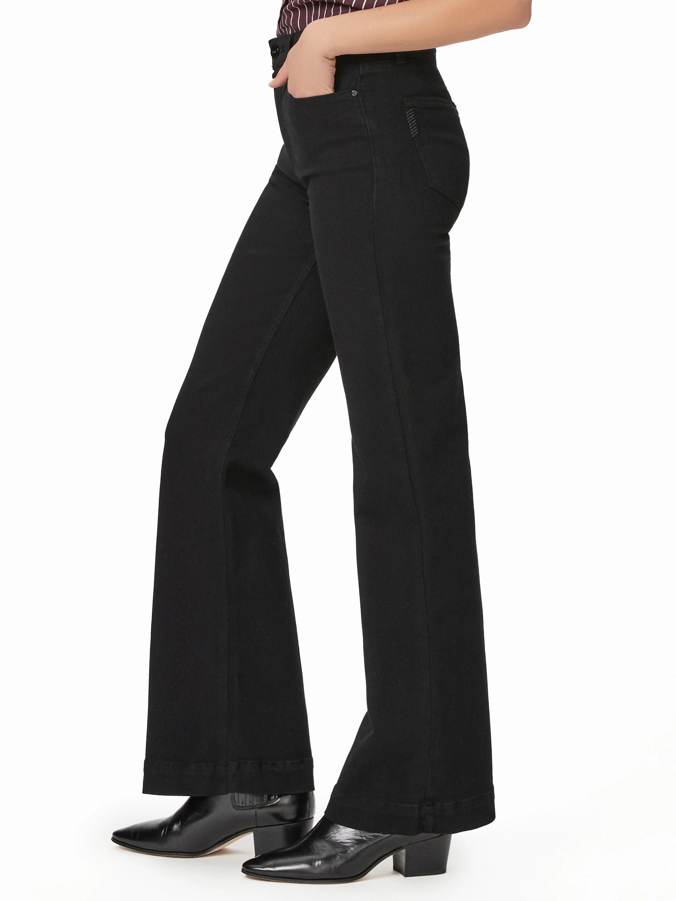 Black high-rise flare jeans shown on model. Fitted through the thigh, flaring out below the knee.