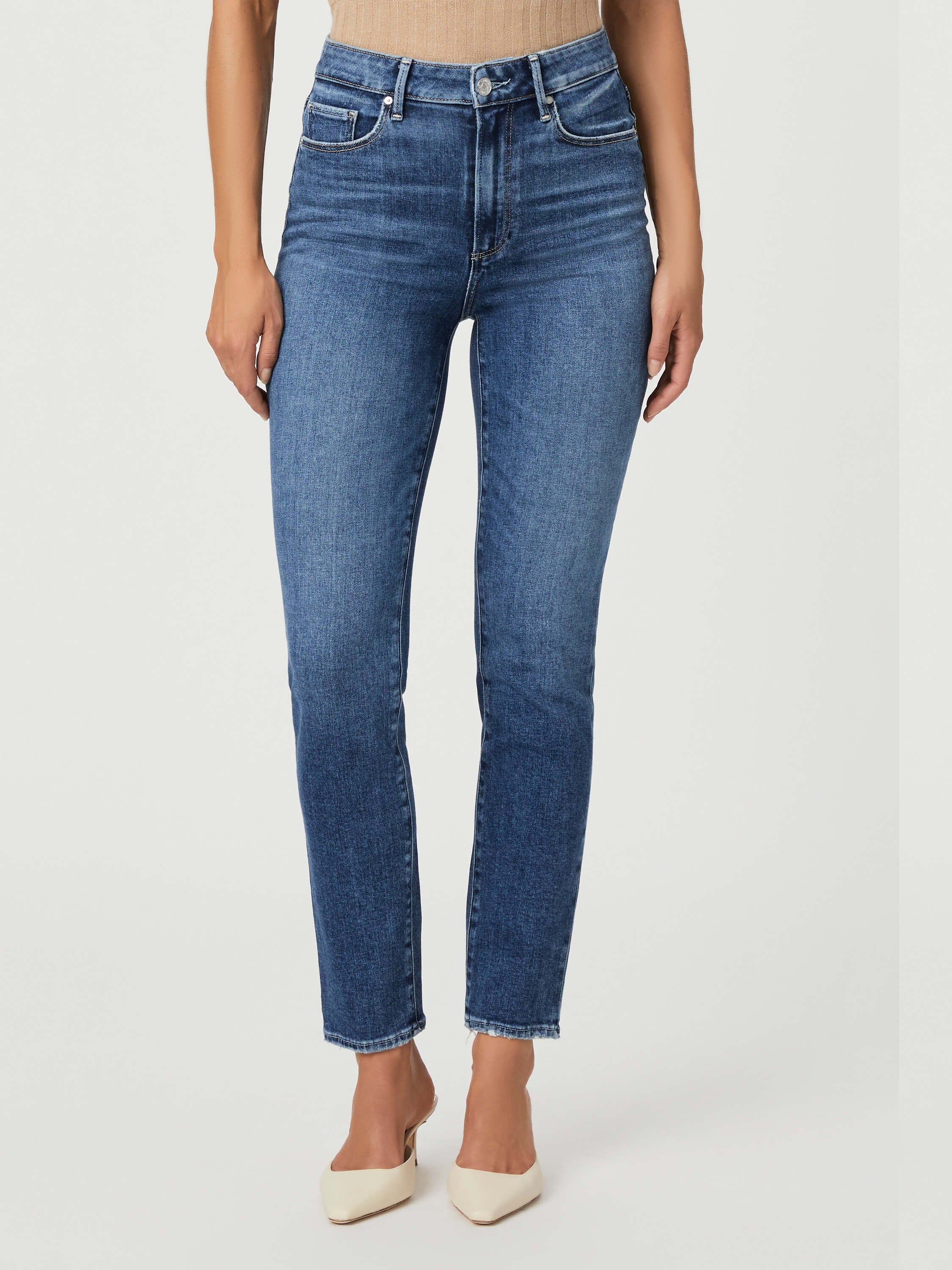 Mid-rise, slim-cut, medium-wash blue jeans; frayed hem.  Model wears off-white heels.