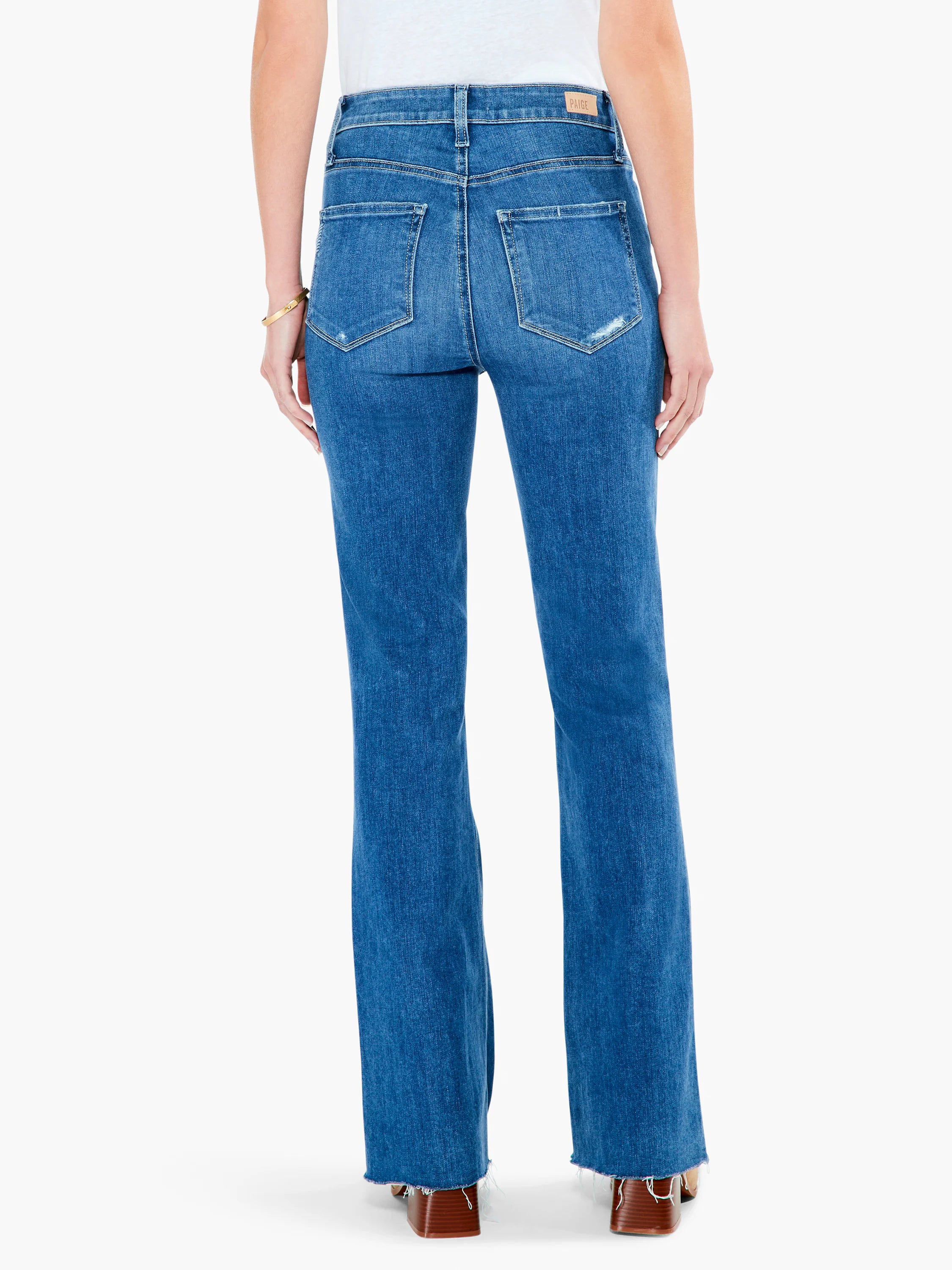 Here's alt text under 125 characters:

Mid-wash blue, high-rise flared jeans with raw hem.  Distressed details at back...