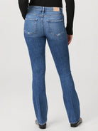 Here's alt text that meets the requirements:

"Back view of medium-wash blue jeans, bootcut style, slight distressing at...