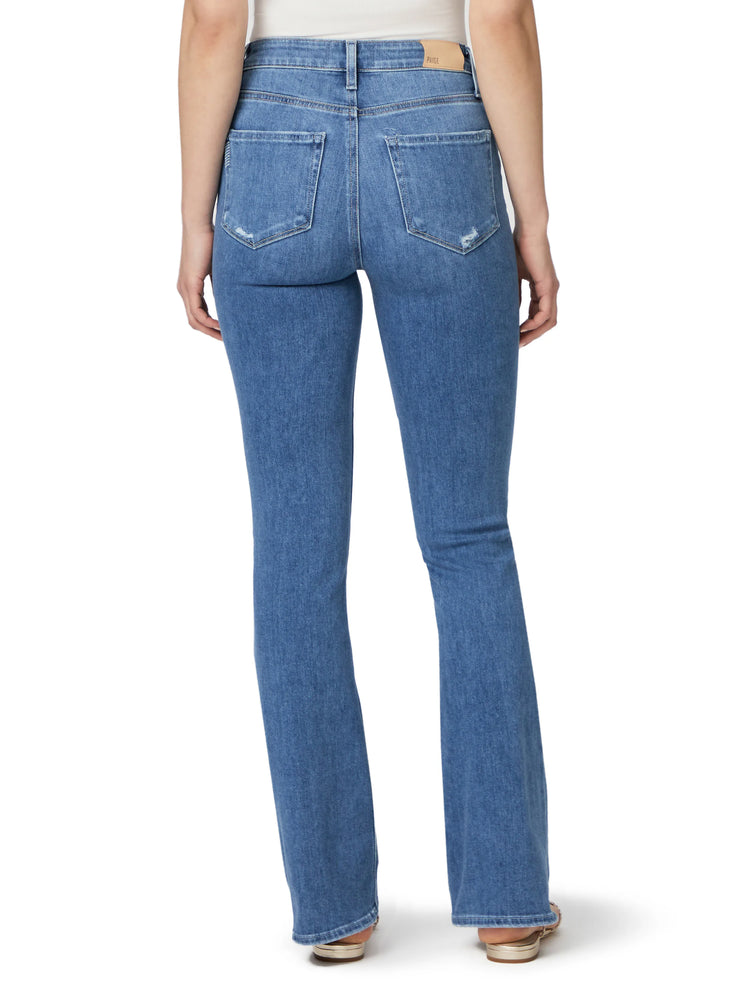 Back view of medium-wash blue bootcut jeans with whiskering and light distressing.  High rise.