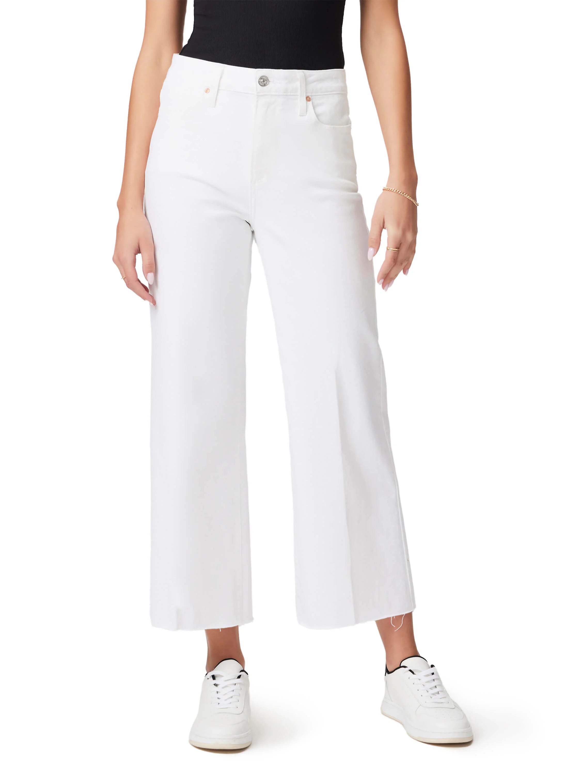 White wide-leg jeans with raw hem, shown on a model.  The jeans are cropped at the ankle.