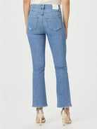 Light wash blue, bootcut jeans; slight distressing; linear coin pocket detail.  Back view.