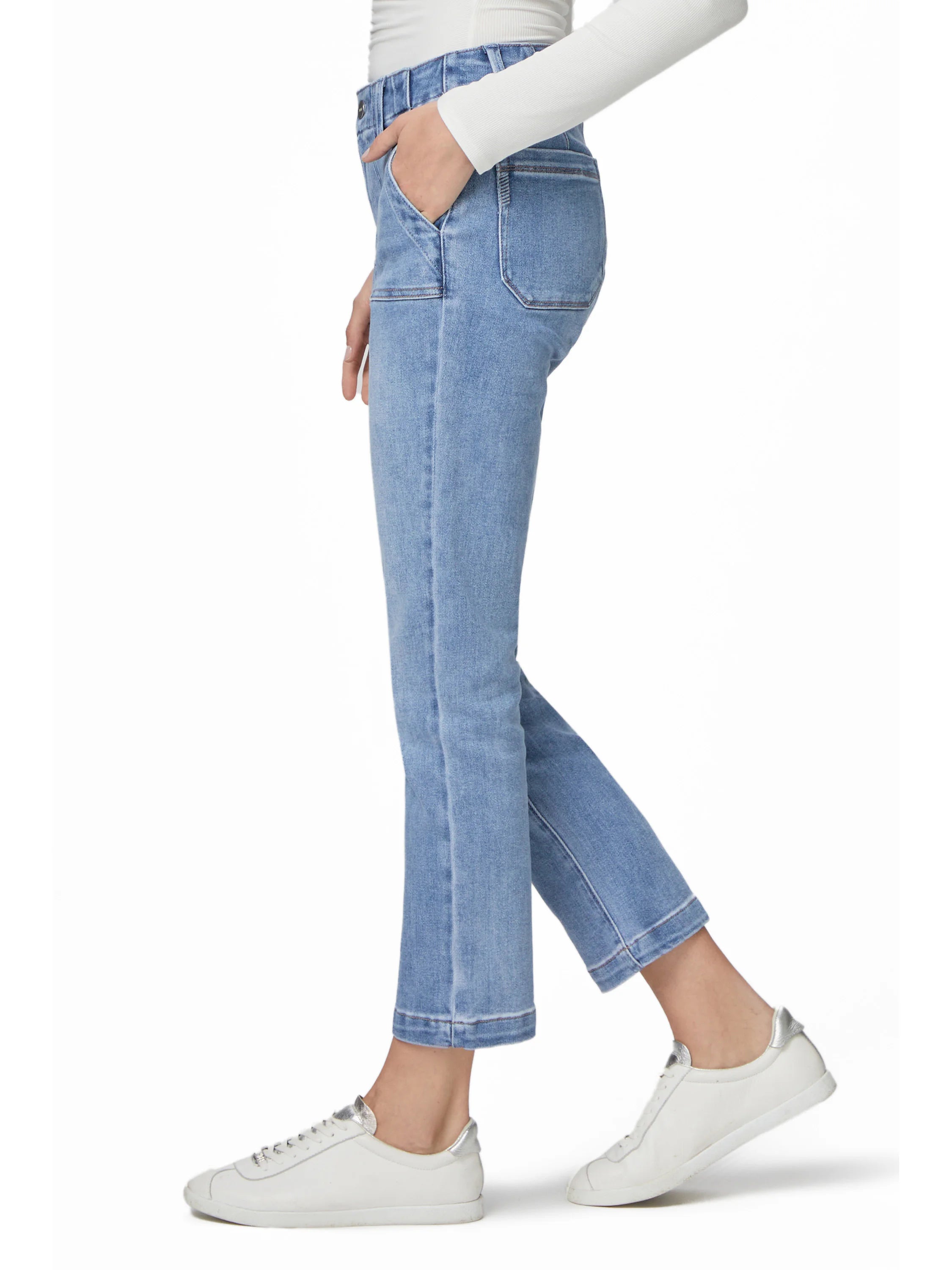 Light blue straight ankle jeans with prominent patch front pockets and a finished hem, worn on a model.