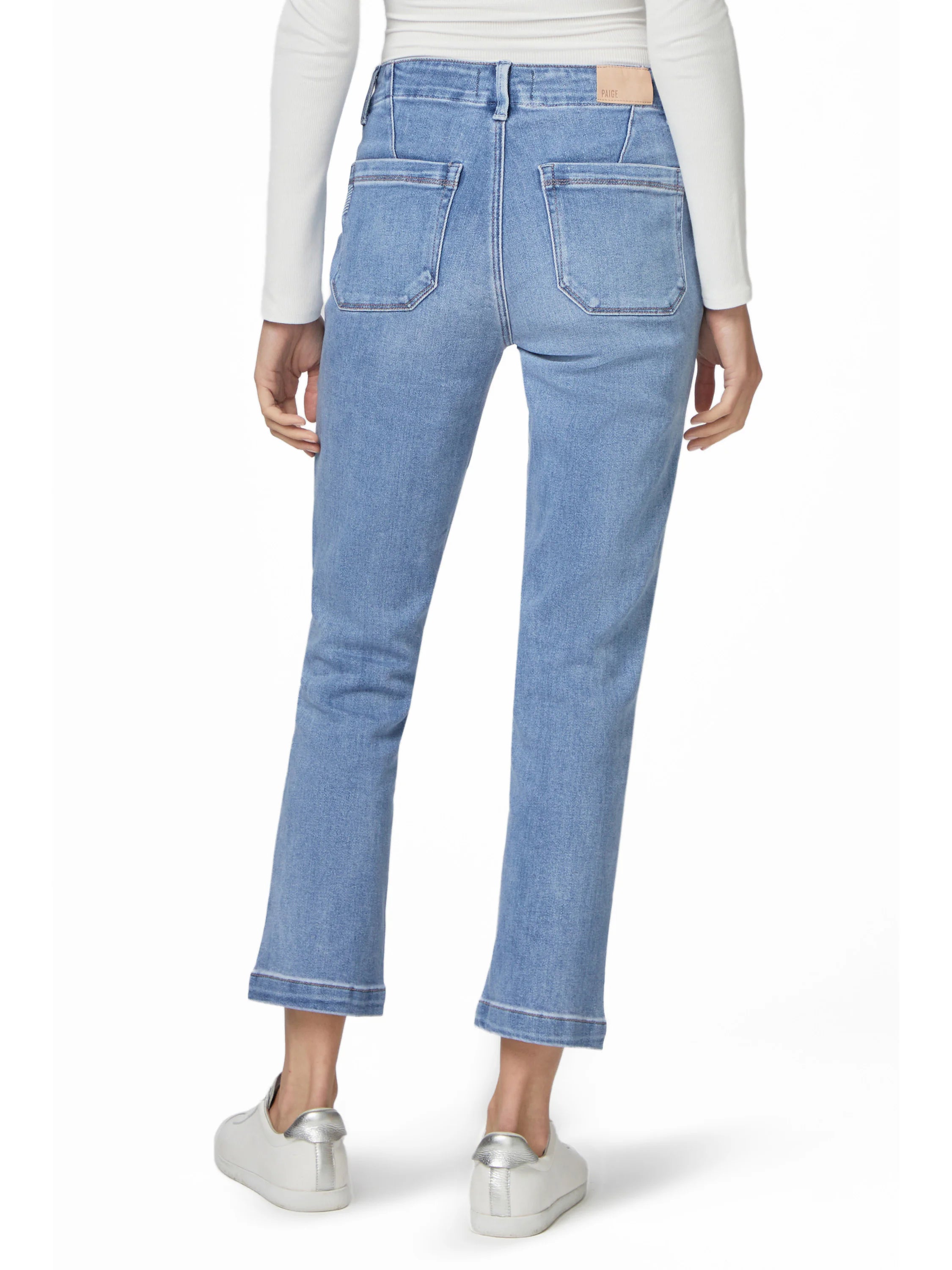 Light blue straight ankle jeans, rear view. Visible back pockets and a wide, finished hem just above the ankle.