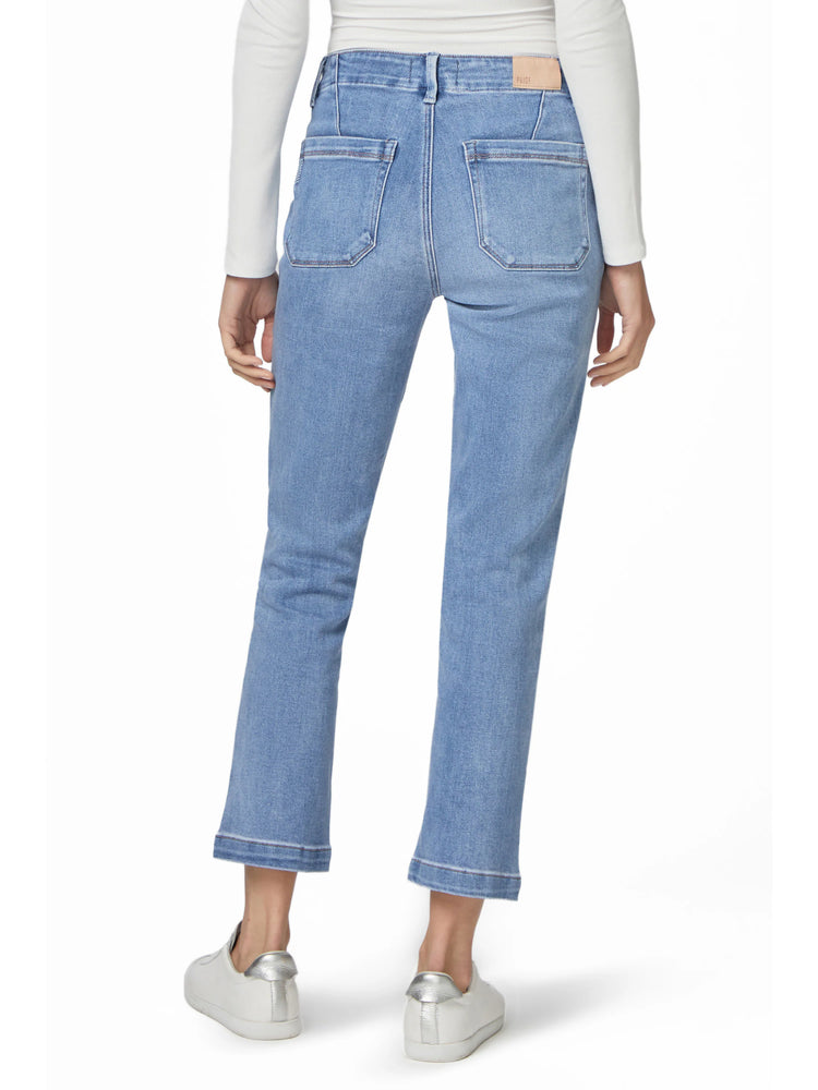 Light blue straight ankle jeans, rear view. Visible back pockets and a wide, finished hem just above the ankle.