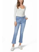 Light blue straight ankle jeans with prominent front patch pockets and a visible cuffed hem.