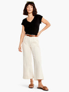 Off-white, wide-leg cropped jeans;  high-waisted with a brown belt.