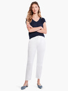 White cargo pants with side pockets; model wears dark navy top and light blue shoes.