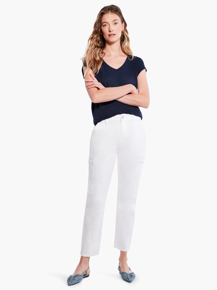 White cargo pants with side pockets; model wears dark navy top and light blue shoes.