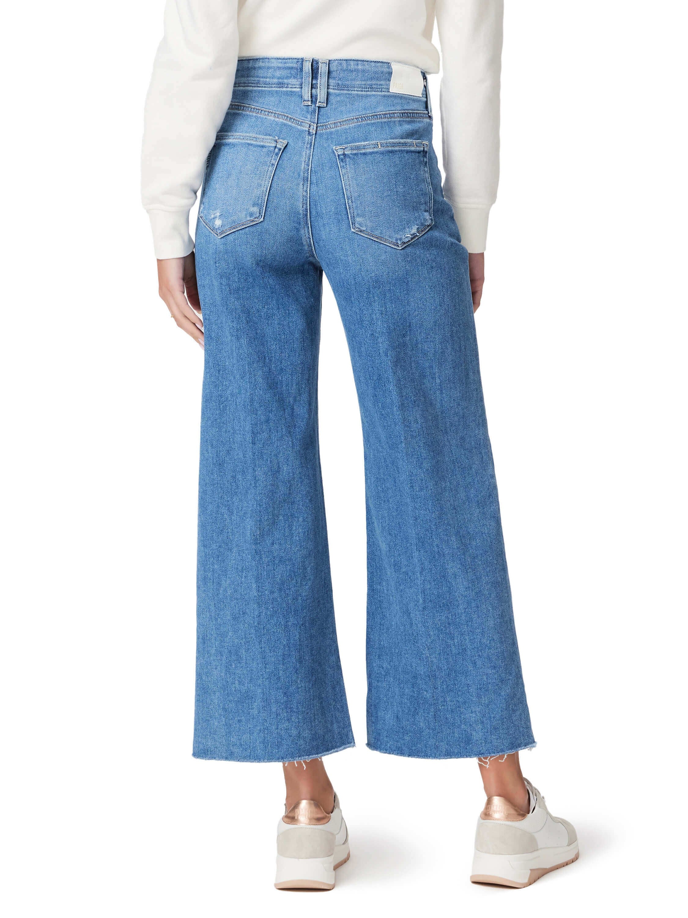 Here's alt text for the image, keeping it under 125 characters:

"Rear view of light wash, wide-leg jeans with frayed...