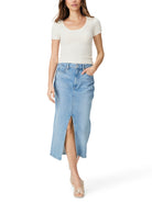 Light blue denim midi skirt with a front slit.  The model is wearing a cream-colored top.