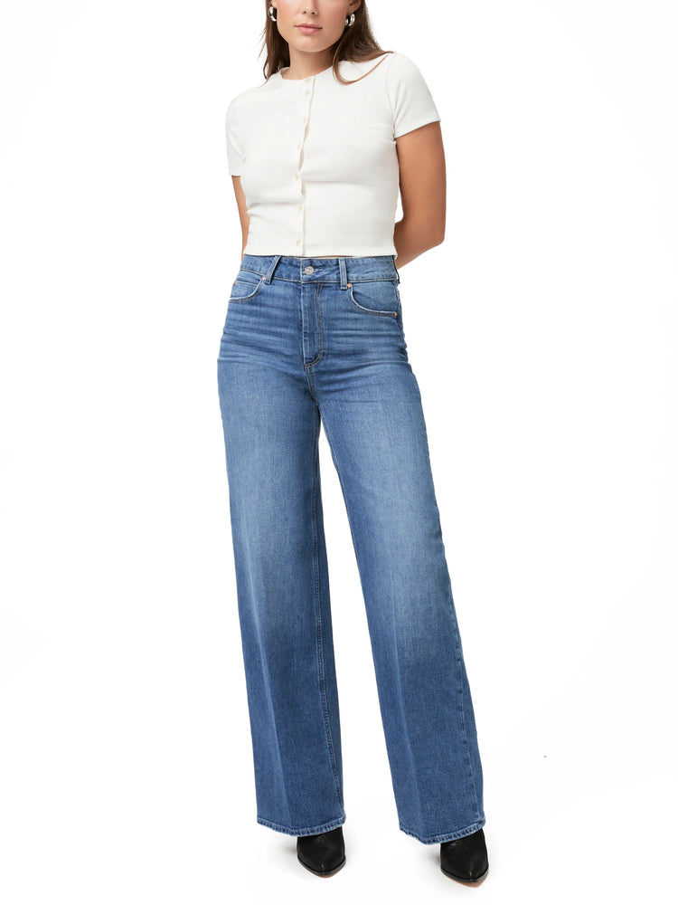 Paige Sasha jeans:  Light wash blue, wide-leg, high-waisted denim.  Model wears off-white top.