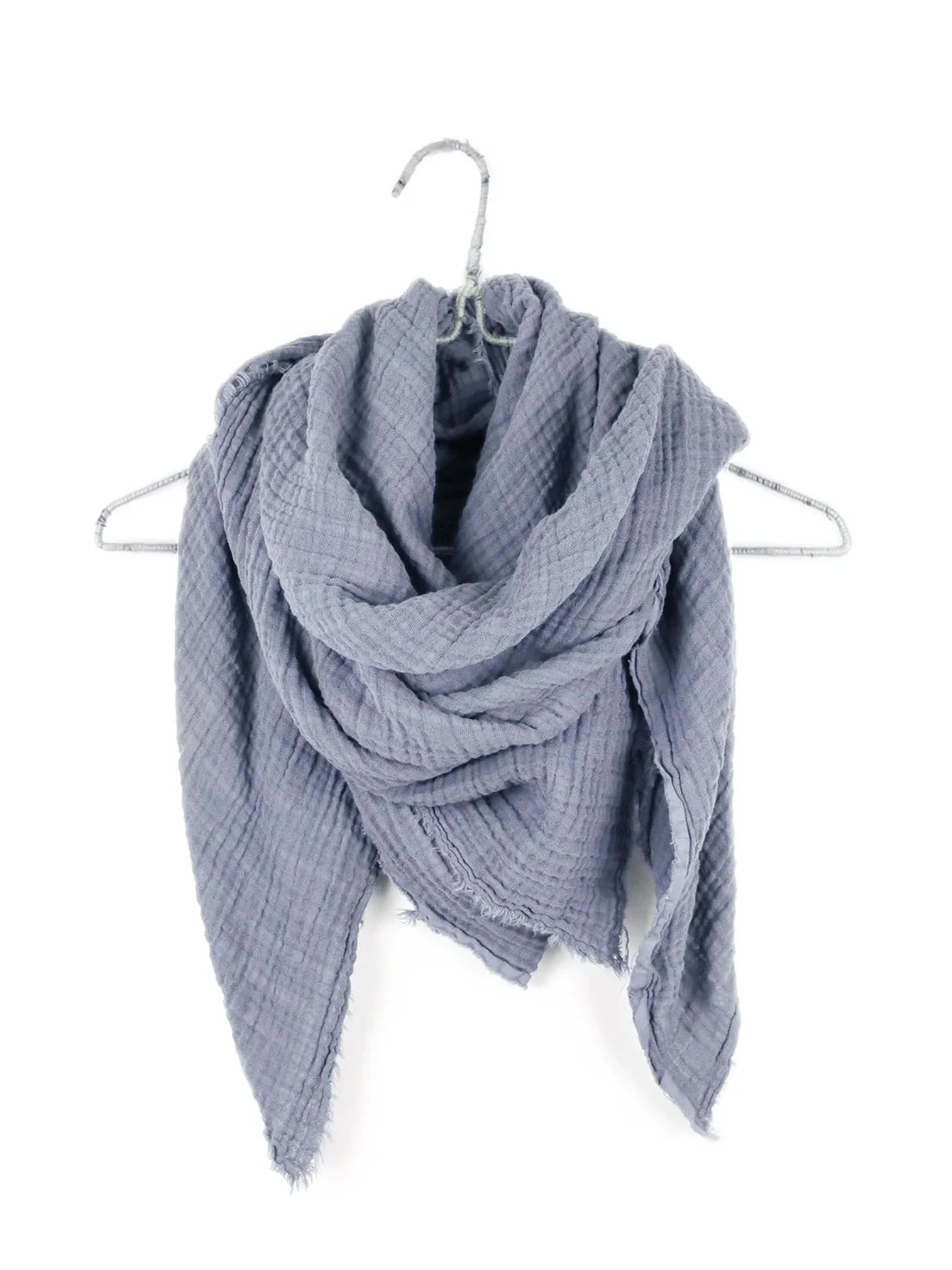 Wrinkled blue-grey double gauze scarf draped over a hanger, with subtly frayed edges.