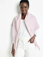 Light pink double gauze scarf; textured fabric, slightly frayed edges.