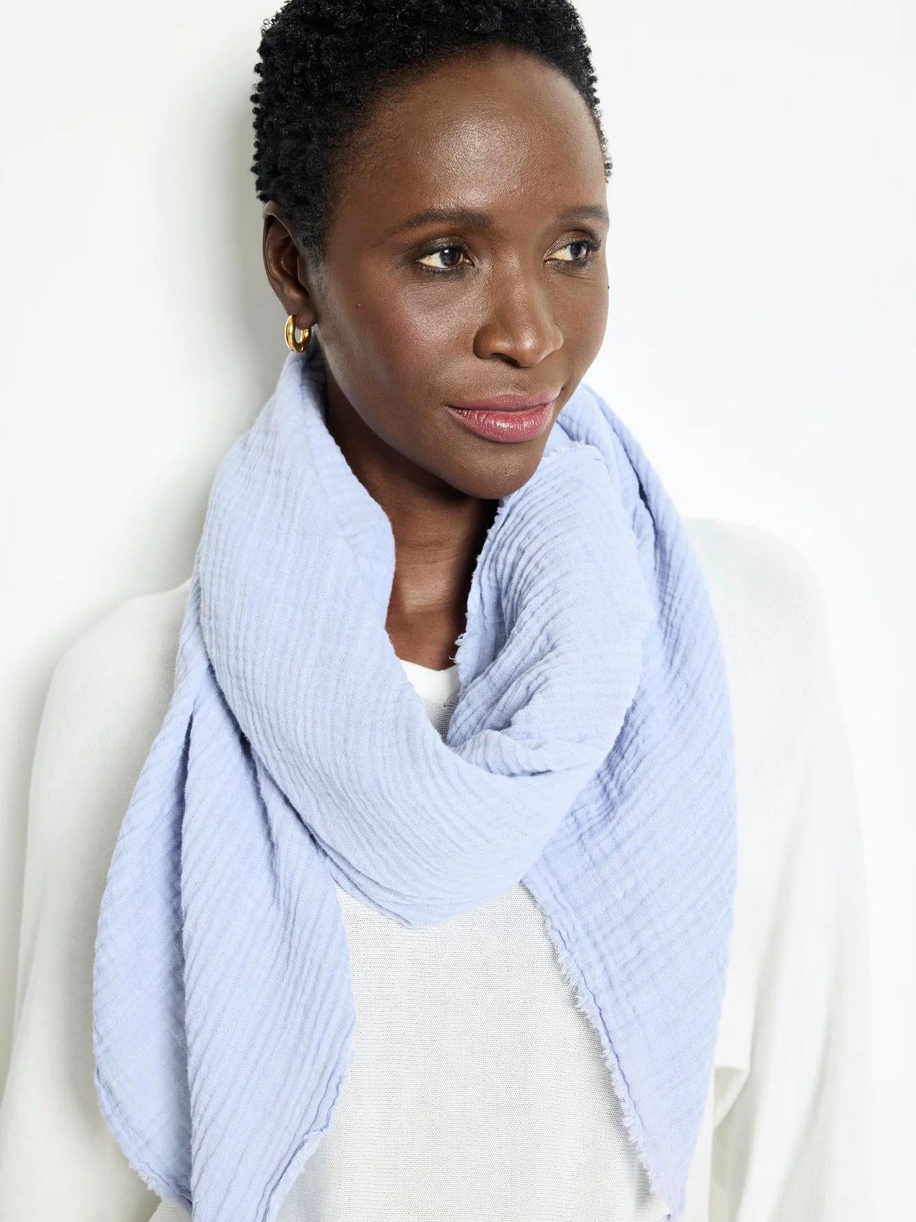 Light blue, textured double gauze scarf.  Slightly frayed edges. Square shape.