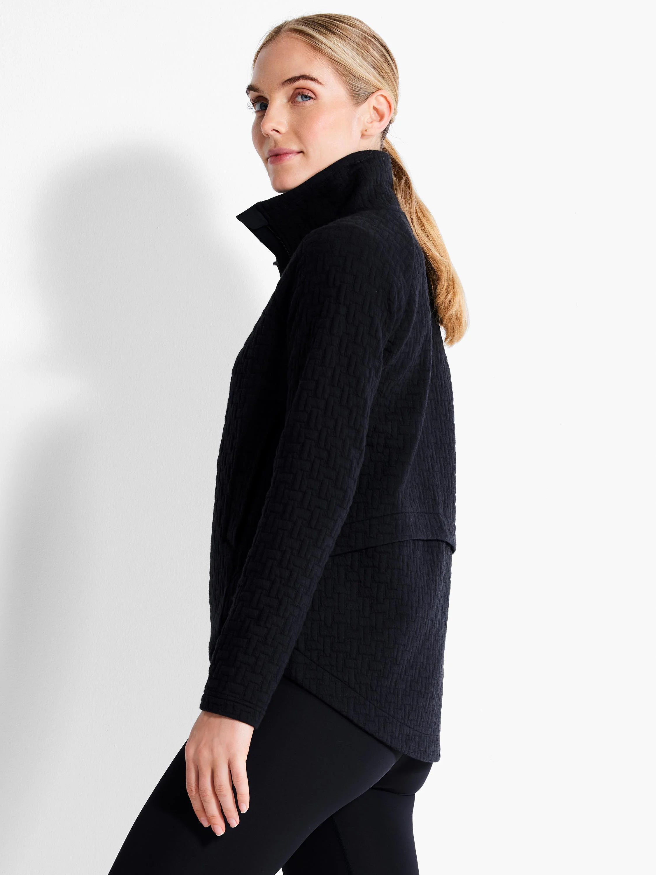 Black jacket with a high collar and a textured quilt pattern.