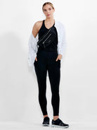 White long-sleeved button-down shirt, styled open over a black tank top.