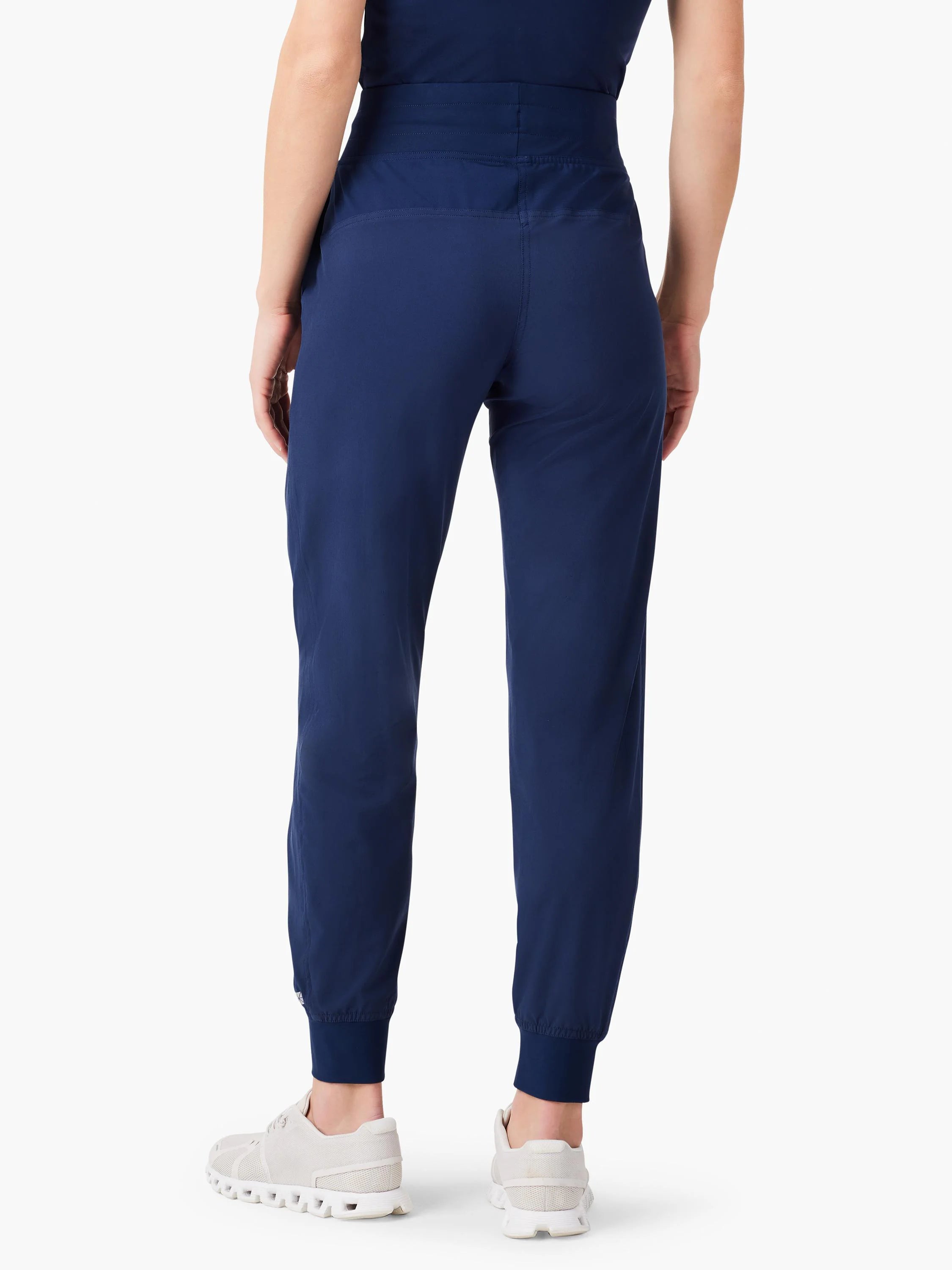 Navy blue high-waisted jogger pants with a wide waistband and elastic ankle cuffs, shown from the back on a person.