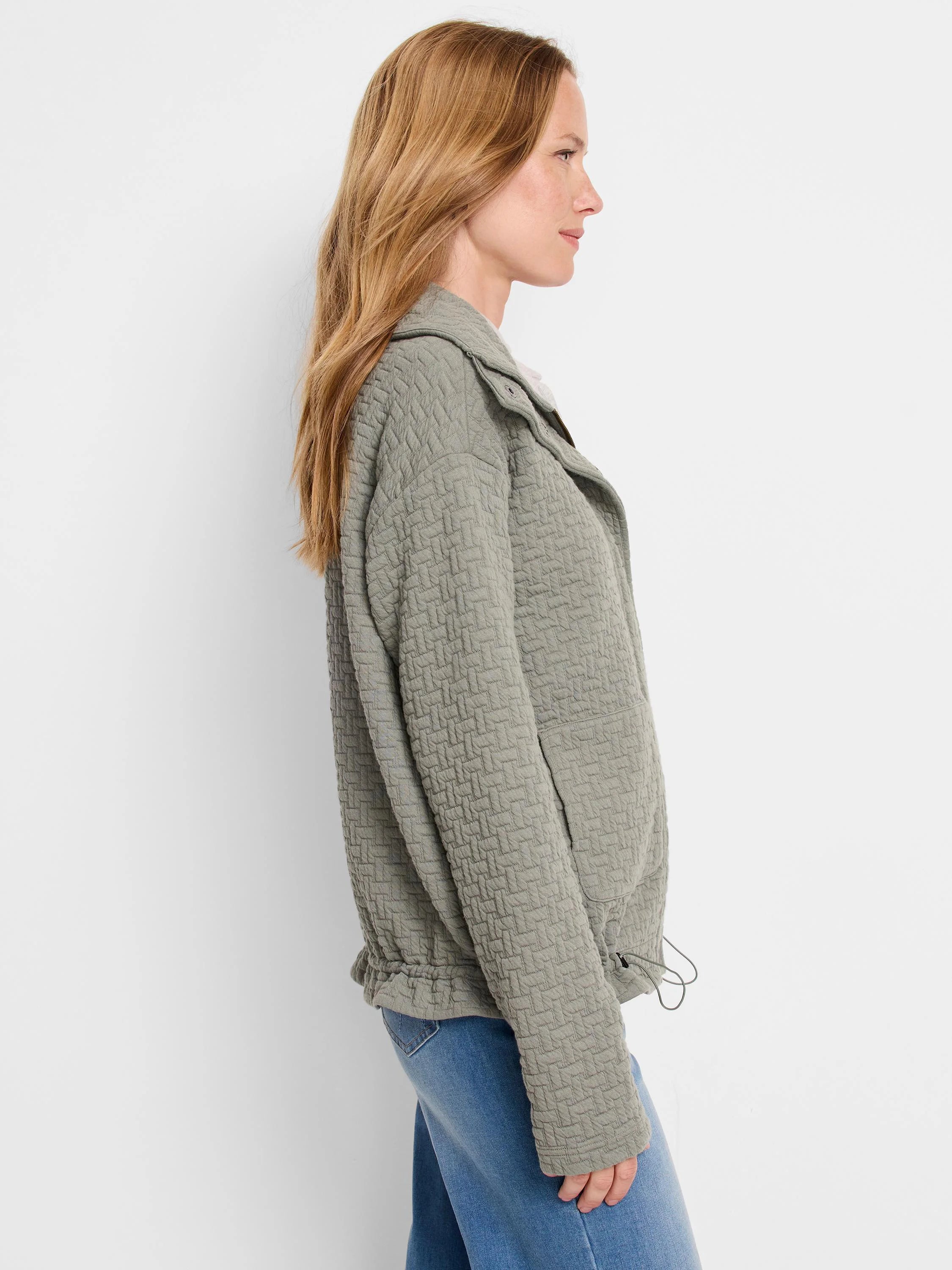 Sage green quilted jacket, long sleeves, zipper front, and drawstring waist.  A small pocket is visible.