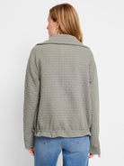 Sage green quilted jacket, textured weave.  Long sleeves, collared.  Shown from the back.