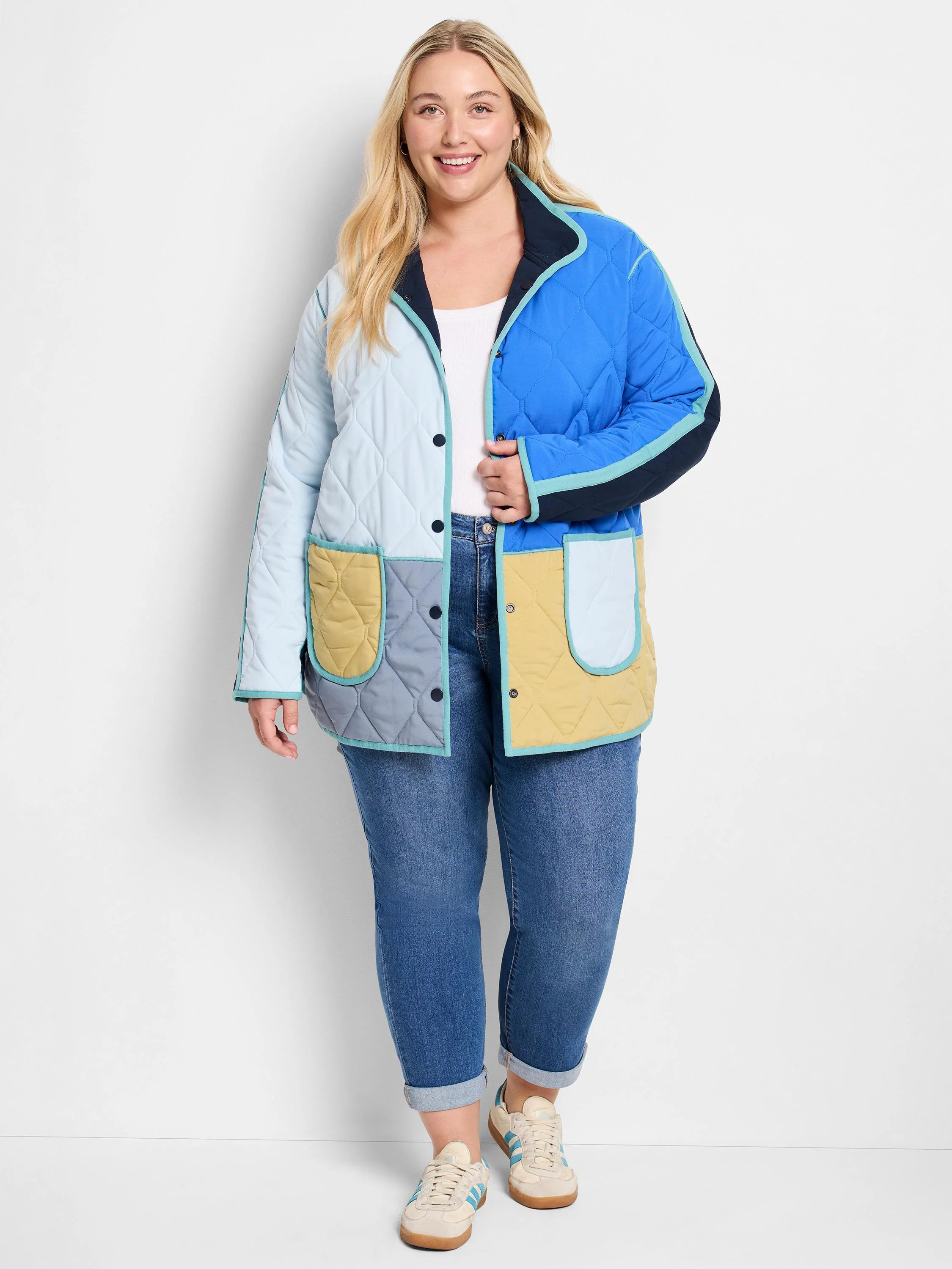Quilted color-block coat in light blue, royal blue, yellow, grey, navy, teal trim. Features snap buttons and patch pockets.
