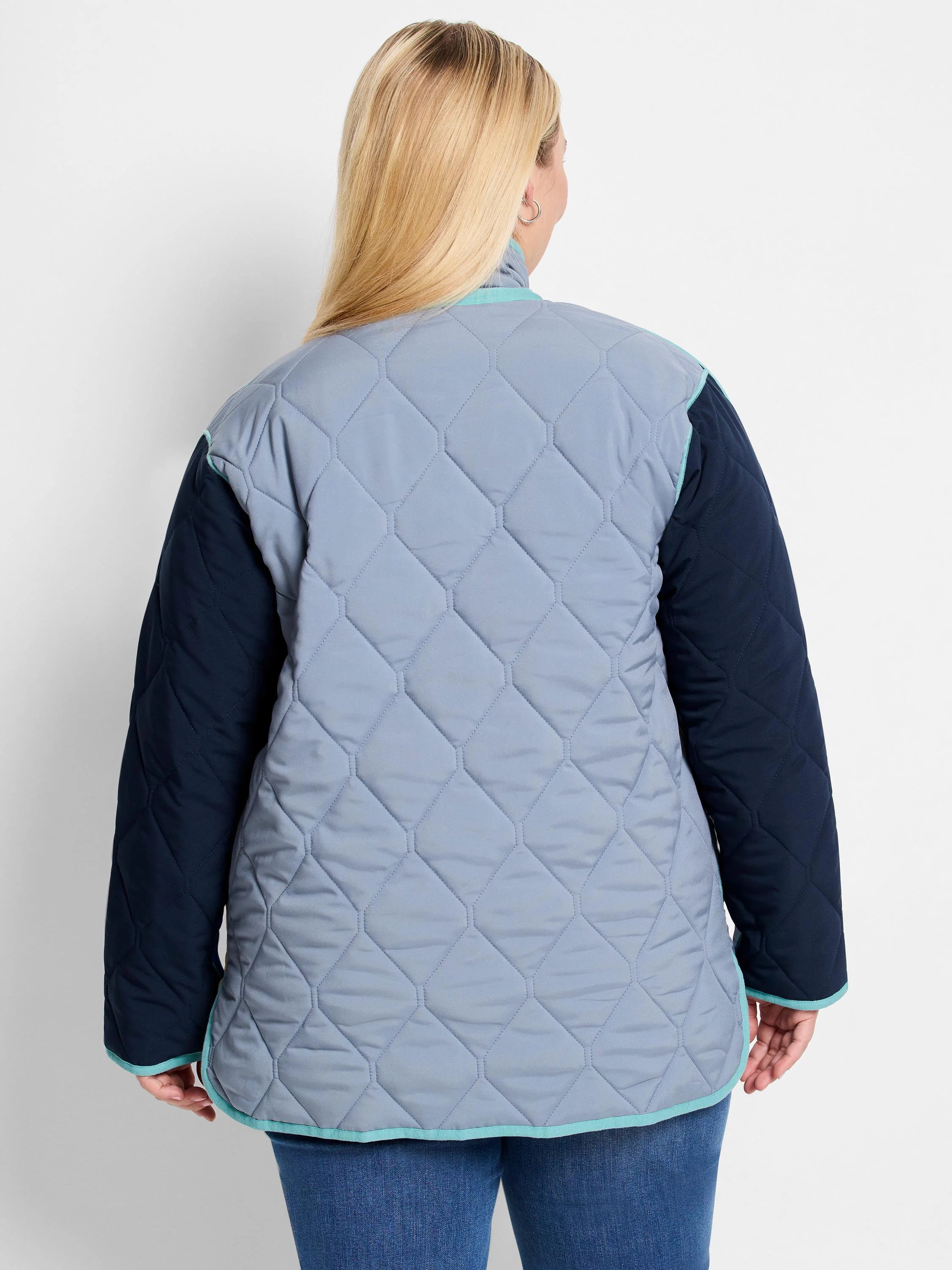 Quilted coat: light blue-grey body with dark blue sleeves and teal trim. Hexagonal pattern visible.
