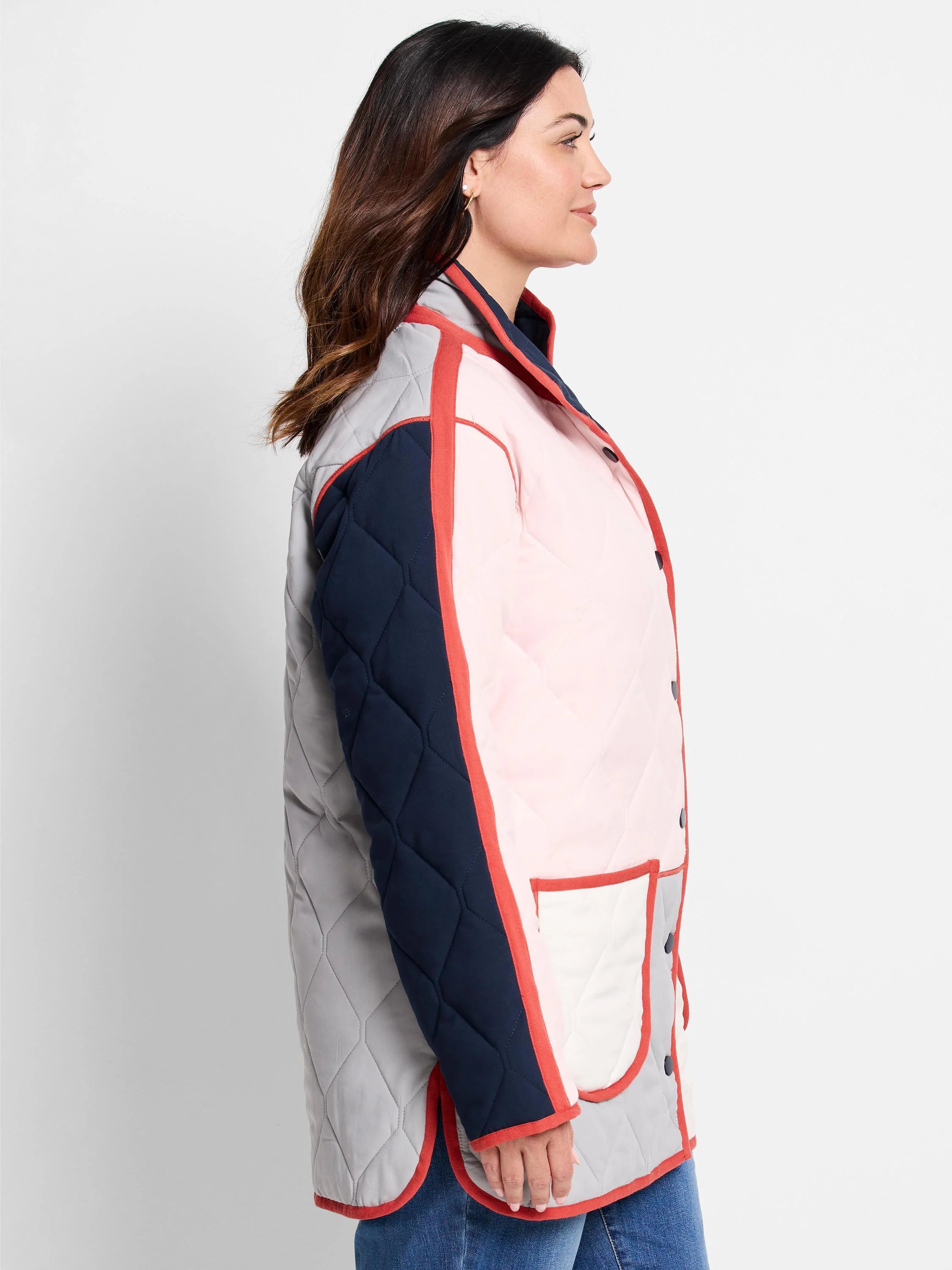 Quilted coat: grey, navy, pink color blocks with red-orange piping, white pocket detail, and front buttons.