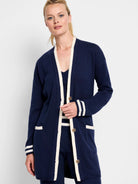 Navy blue cardigan with cream trim on placket, cuffs, and pockets. Button front.