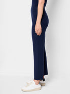 Dark navy blue ribbed knit pants, cropped, shown on a model.