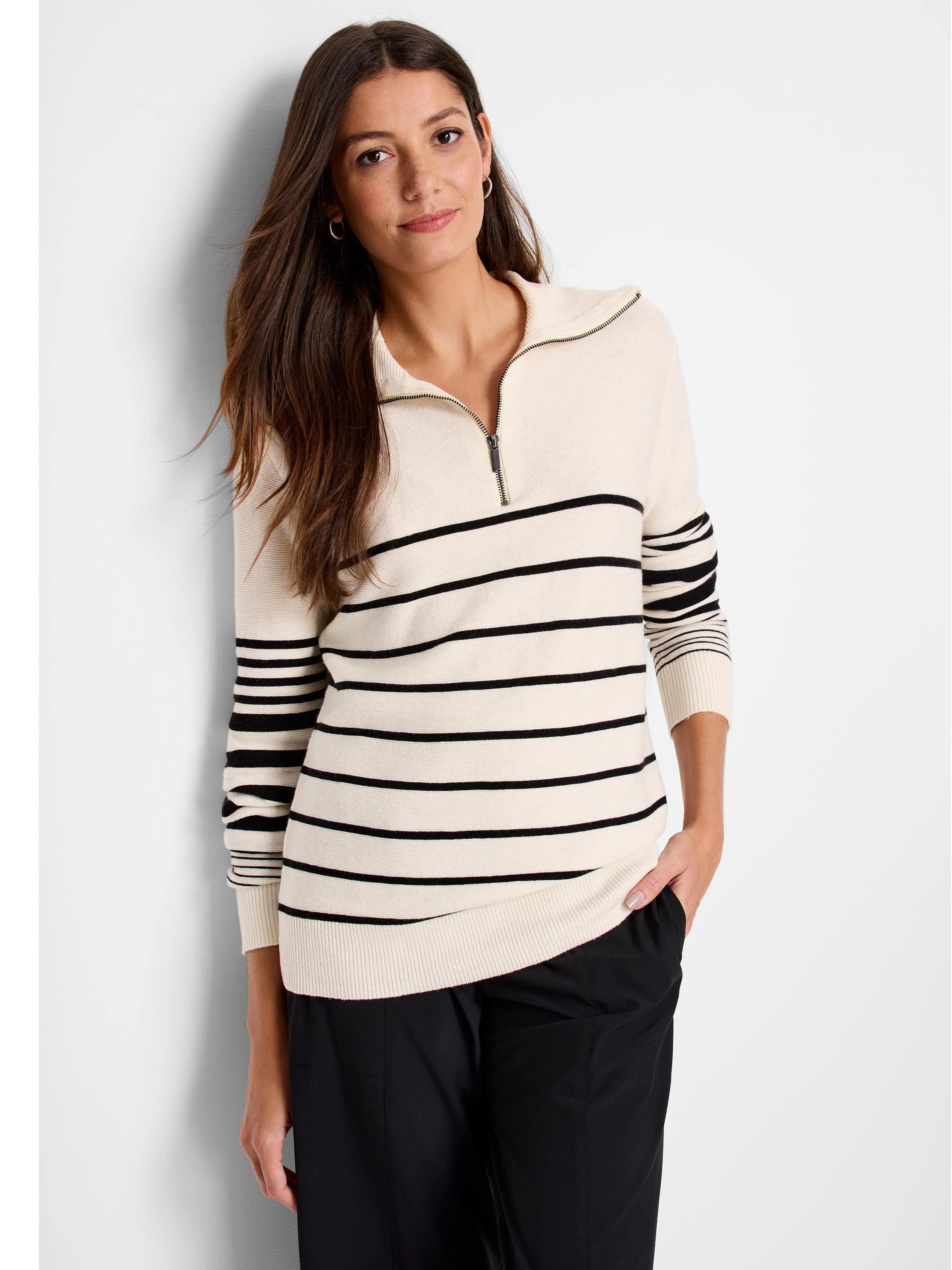 Cream-colored sweater with horizontal black stripes, half-zip closure.
