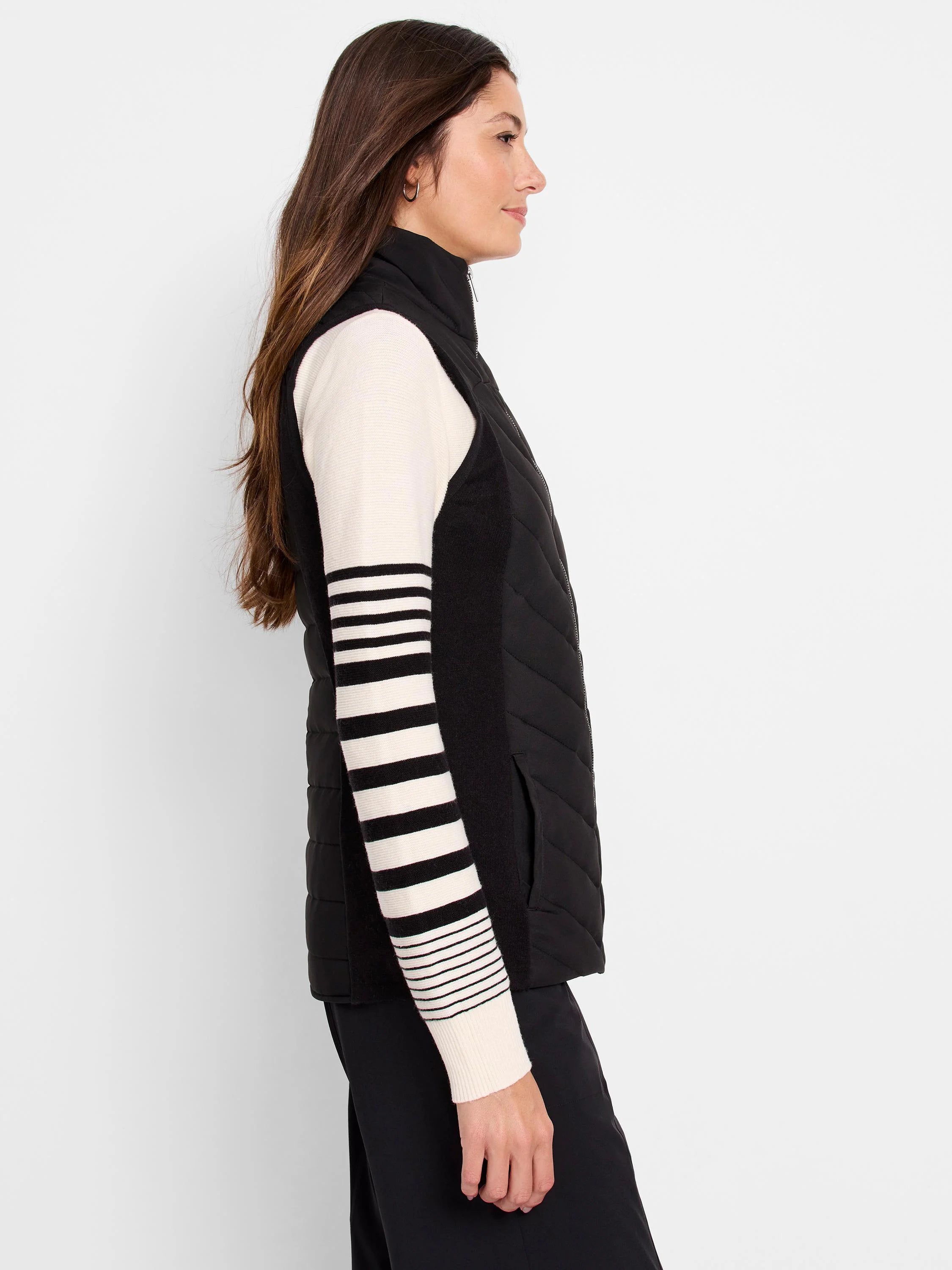 Black quilted puffer vest with black and off-white knit trim.  Side view.