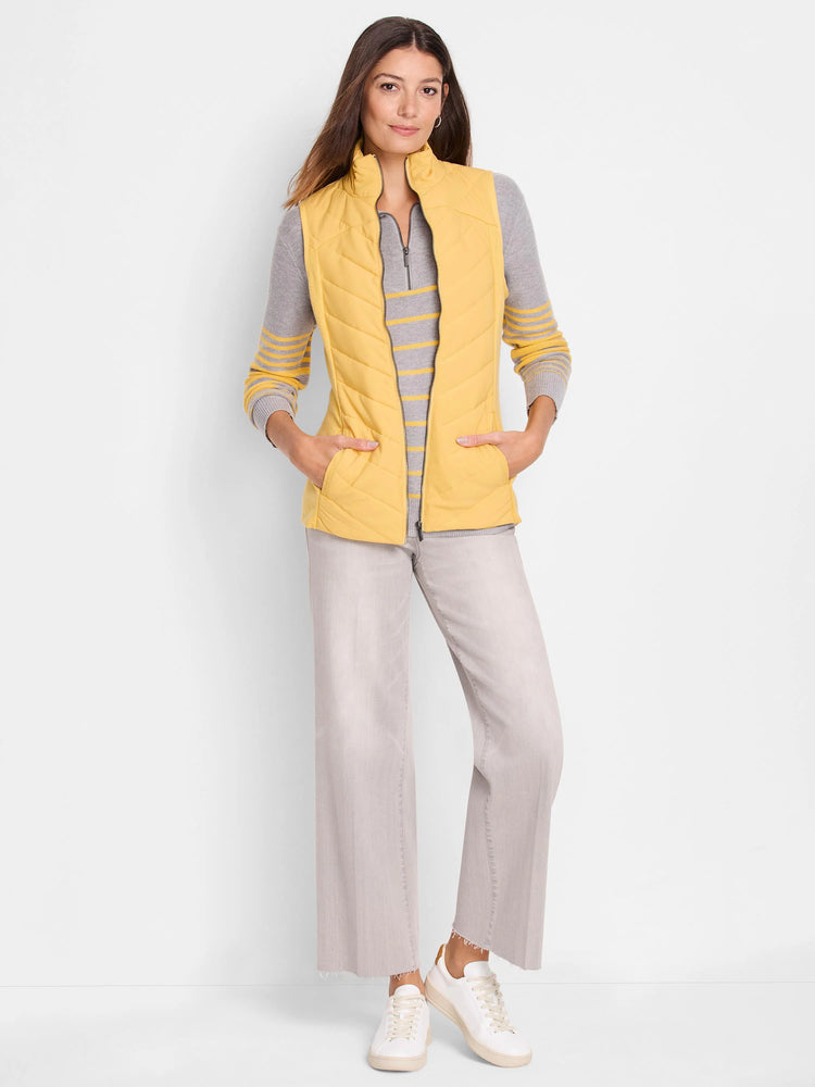 Mustard yellow quilted puffer vest with zipper and pockets.  Shown with gray striped top and light gray pants.