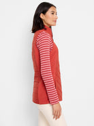 Burnt orange quilted puffer vest.  Diagonal quilting. Knit trim.  Side zip closure.