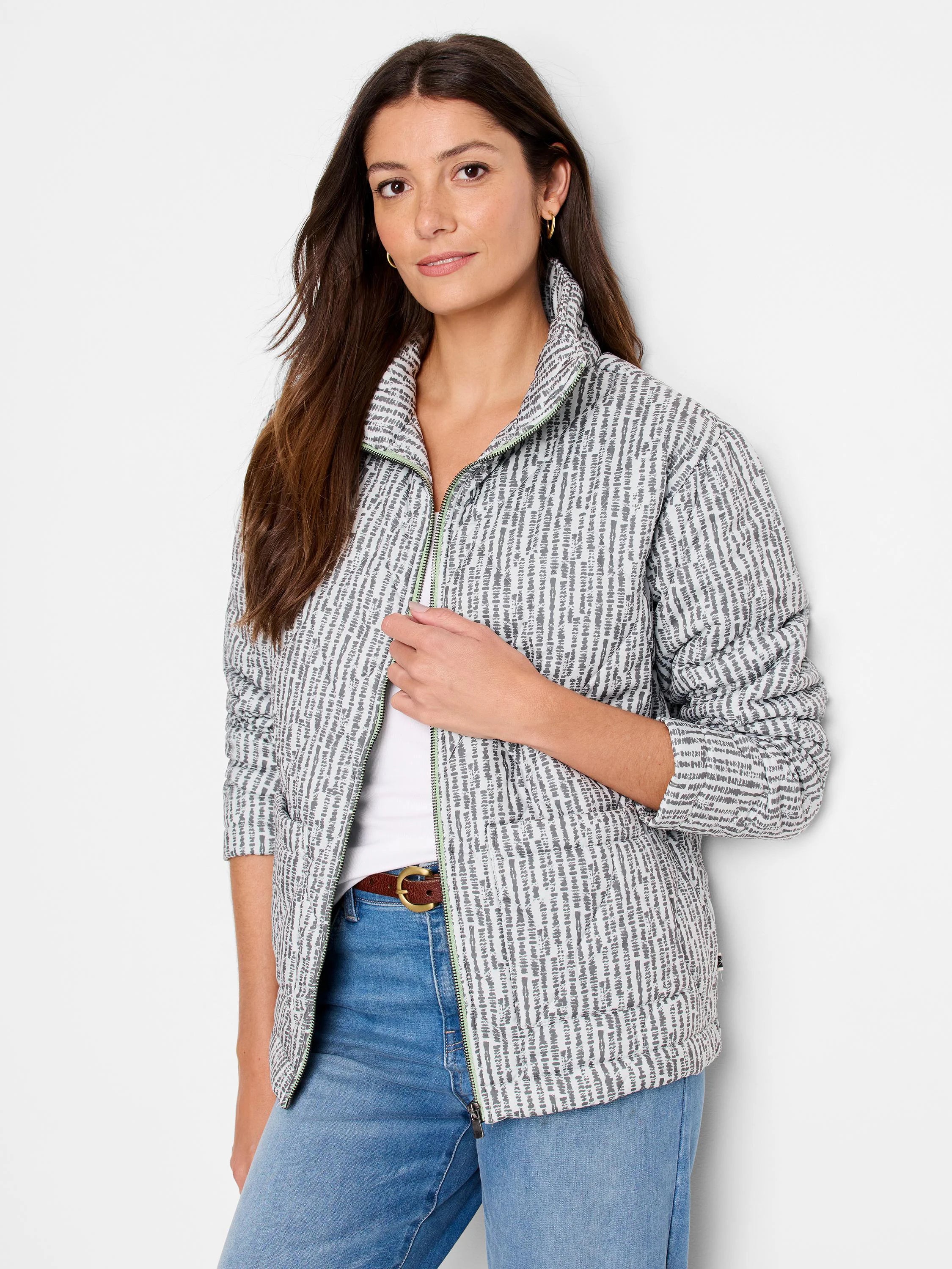 White/light grey quilted puffer jacket with dark grey abstract pattern, bright green zipper, and stand-up collar.