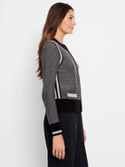 Gray and black zip-front cardigan.  Features light gray stripes on the sleeves and sides.  Black bottom band.