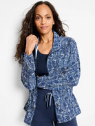 Navy blue zip-front jacket with white abstract leaf pattern.  Long sleeves.