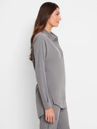 Grey long-sleeved collared shirt with a loose fit and side slits.