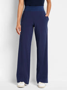 Navy blue wide-leg pants with a dark blue waistband and pockets.