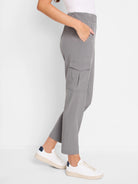 Grey cargo pants with elastic waist, flap cargo pocket, and tapered ankle-length legs.