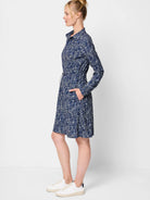 Navy blue mini dress with a white abstract print.  Long sleeves, collared neckline, and drawstring waist.  Features pockets.