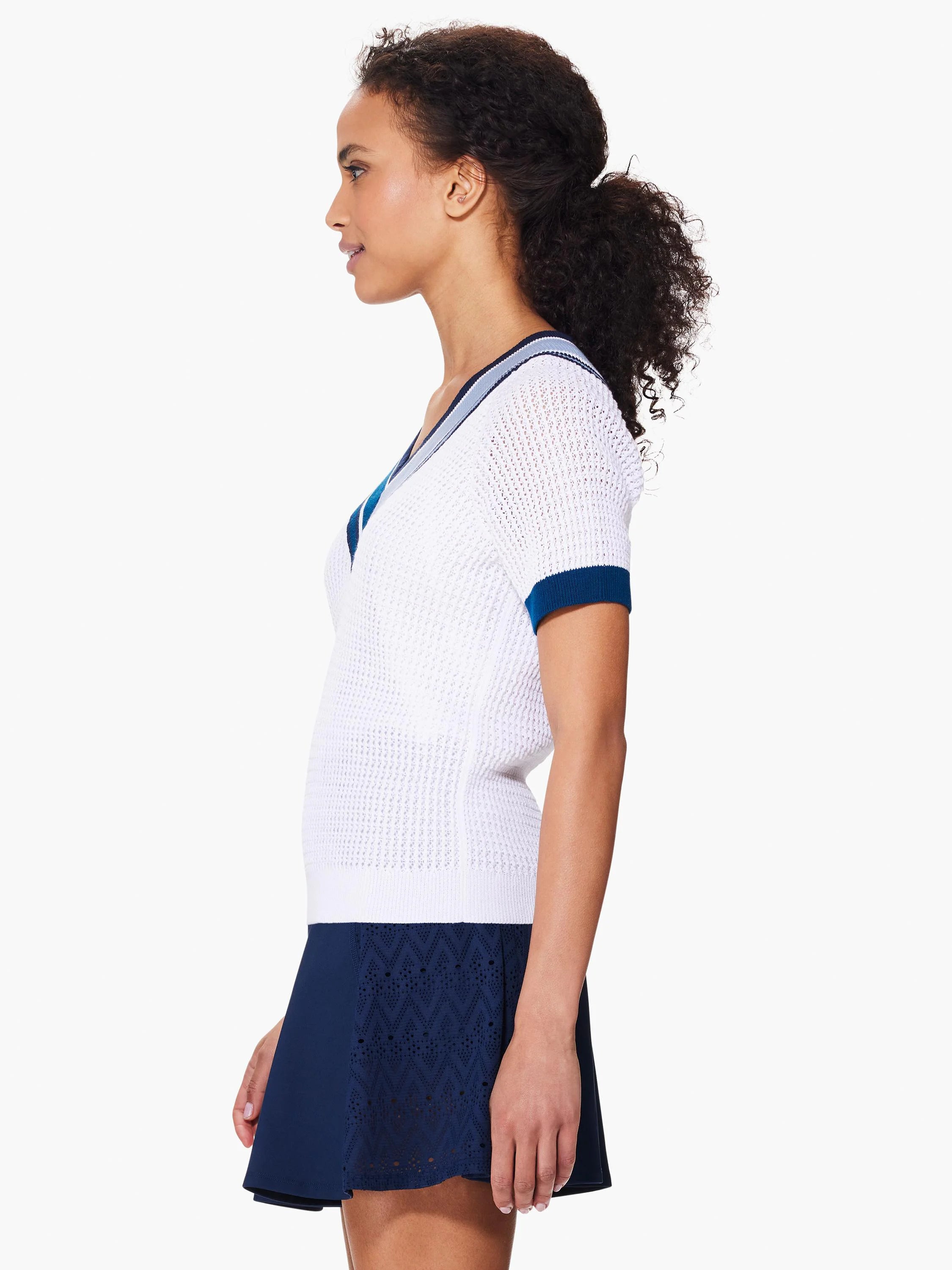 White v-neck sweater with short sleeves and navy blue trim.  Open knit texture.
