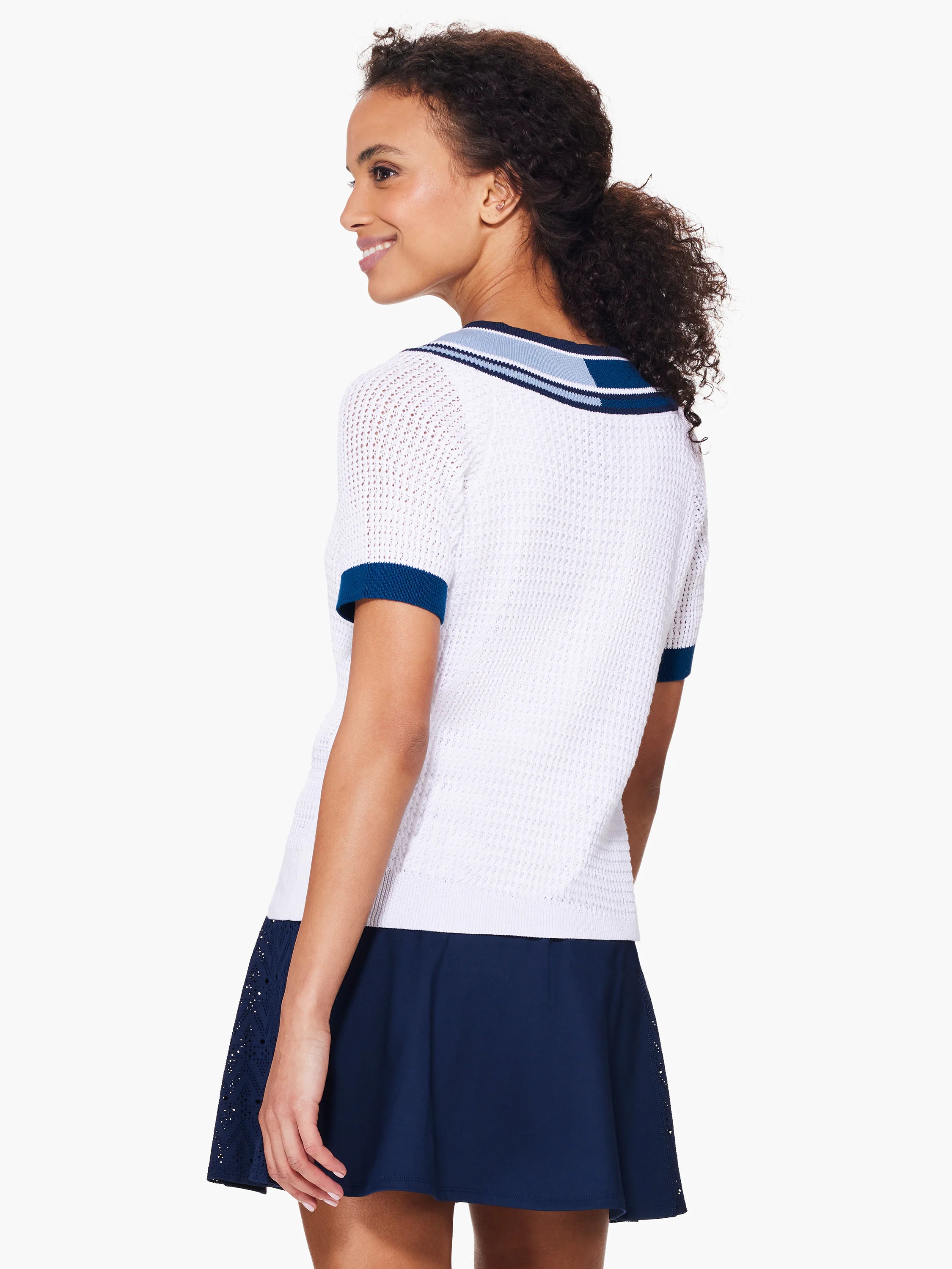 White v-neck sweater with navy and light blue stripes at collar and short sleeves.  Open knit texture.