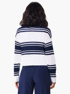 Rear view of white and navy blue horizontally striped zip-front sweater. Knit fabric.