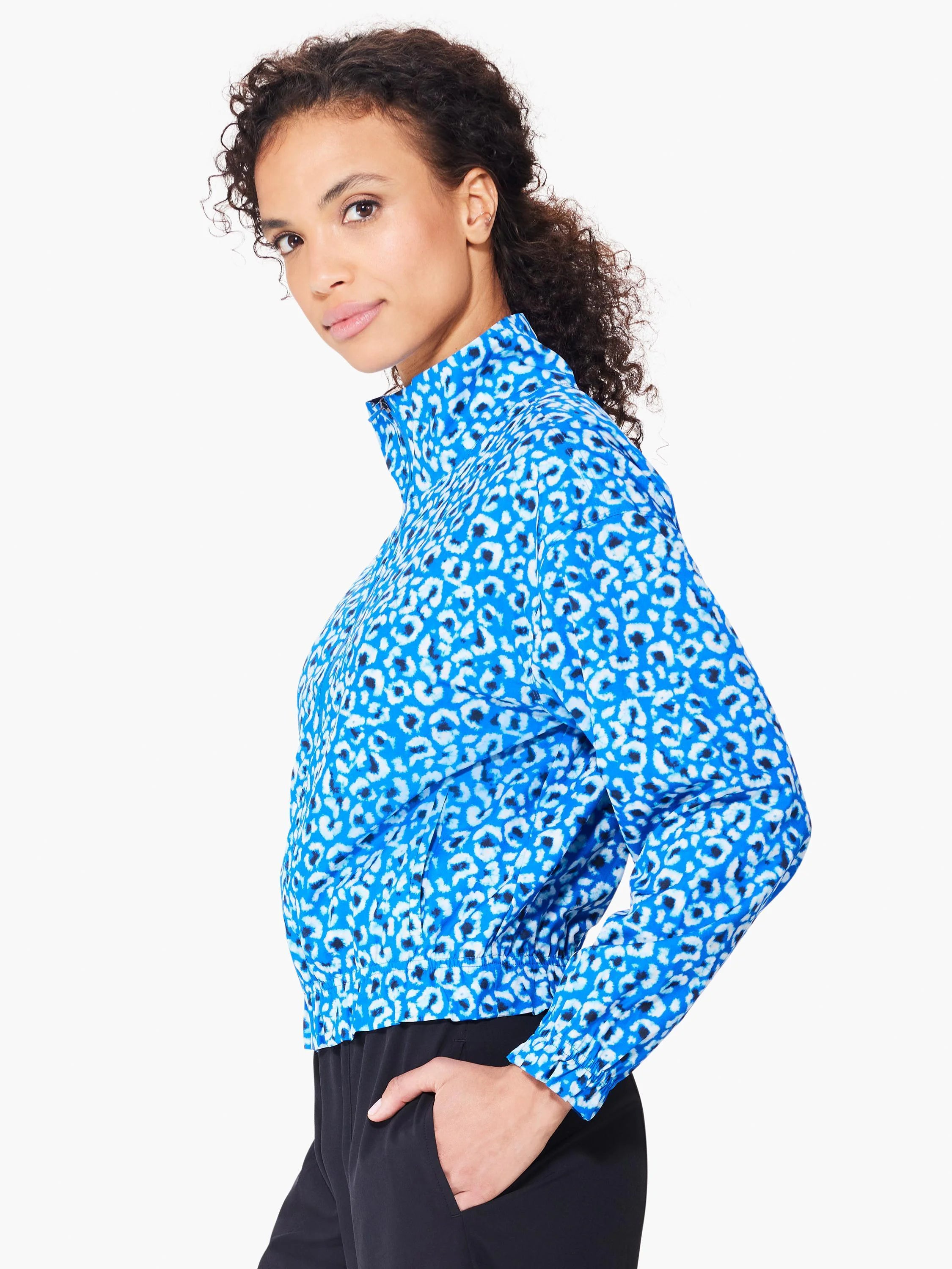 Blue jacket with white and dark blue leopard print.  Half-zip closure, long sleeves, and elasticized hem.