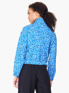 Blue jacket with white and dark blue leopard print.  Long sleeves, cropped length.
