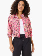 Pink jacket with a dark-pink, beige, and black floral pattern.  Zip front, elasticized cuffs.