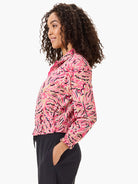 Pink jacket with beige, black, and navy floral pattern.  Long sleeves, banded cuffs, and drawstring waist.