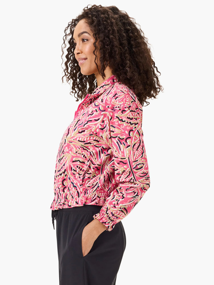 Pink jacket with beige, black, and navy floral pattern.  Long sleeves, banded cuffs, and drawstring waist.