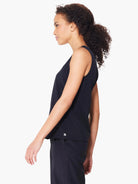 Black sleeveless top, seamed detail, small logo.  Side profile view on model.
